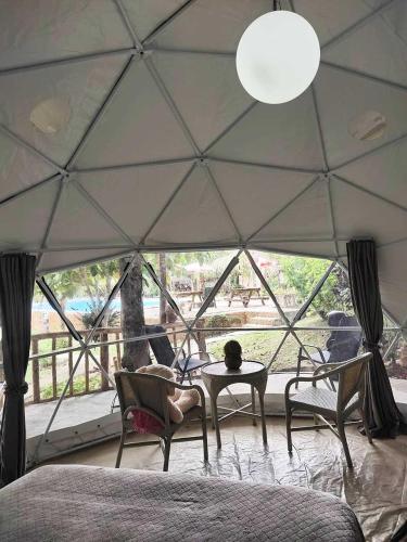 a room with a tent with a table and chairs at Eco Glamping Treehouses Closest Resort To All Tourist Attractions in Balilihan