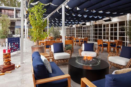a patio with chairs and a table with a fire pit at Sheraton Universal in Los Angeles