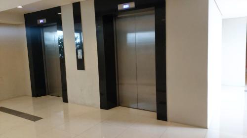 a row of elevator doors in a building at Apartement Bogor Icon Syariah, View Gunung Salak in Bogor