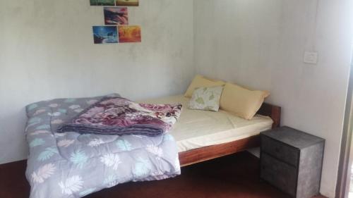 a small bed in a corner of a room at Damfu Basera Homestay in Kurseong