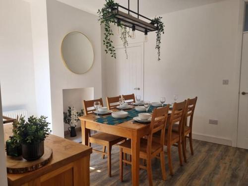 a dining room with a wooden table and chairs at Home from home in Maryport in Maryport