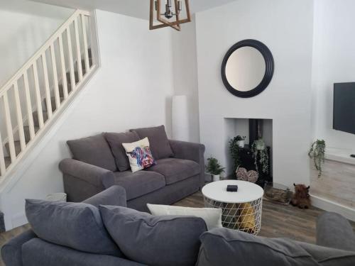 a living room with a couch and a table at Home from home in Maryport in Maryport