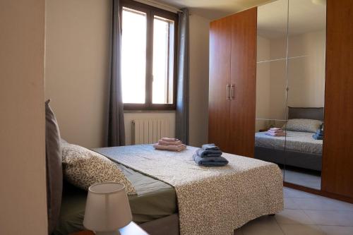 a bedroom with a bed with towels on a table at Casa Le corti in Livorno