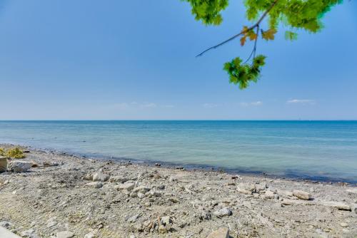 a sandy beach with the ocean in the background at Turtle Cove Bay Beach House about 13 Mi to Buffalo! in Lake View