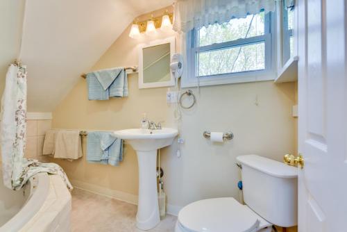 a bathroom with a sink and a toilet and a window at Turtle Cove Bay Beach House about 13 Mi to Buffalo! in Lake View