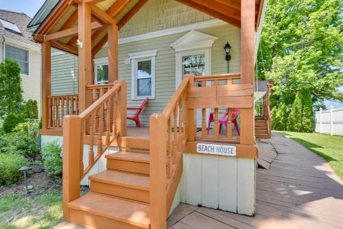 a home with a wooden staircase leading up to a house at Turtle Cove Bay Beach House about 13 Mi to Buffalo! in Lake View