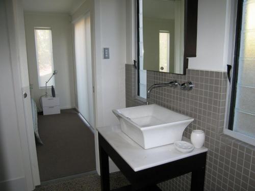 a bathroom with a white sink and a mirror at Quiet Getaway Only Minutes to Beach in Encounter Bay