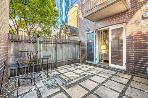 a patio with two chairs and a table and a fence at Old Sydney Comfort Self- Catering in Sydney