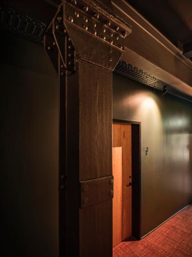 a room with a wooden door and a beam at sly Berlin in Berlin