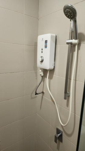 a shower in a bathroom with a hair dryer at 2 Rooms Duplex, I Suite i-City, Up to 4 Pax, Free Wi-Fi, Fully Furnish in Shah Alam