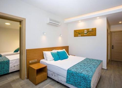 A bed or beds in a room at My Marin Otel