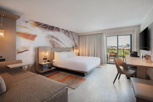 a hotel room with a bed and a desk and a couch at Tucson Marriott University Park in Tucson