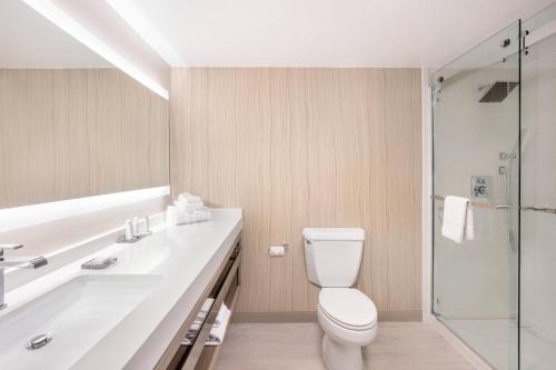 a bathroom with a toilet and a sink and a shower at Tucson Marriott University Park in Tucson