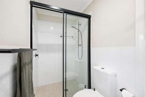 a glass shower in a bathroom with a toilet at The House - The Charles at Broke Hunter Valley Luxury in Broke