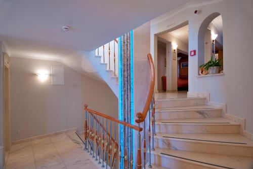a stairway with a blue and white wall at Hotel Sunceva Postelja Brela in Brela
