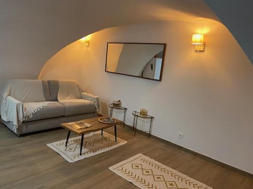 a living room with a couch and a table at L'AGACHON LA CIOTAT VIEUX PORT in La Ciotat
