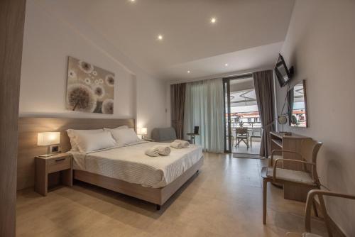 a bedroom with a bed and a living room at Casa de Lapel Kallithea in Kallithea Halkidikis
