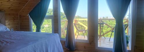 a bedroom with a bed and a view of a balcony at VILLA GANTIADI in Batumi