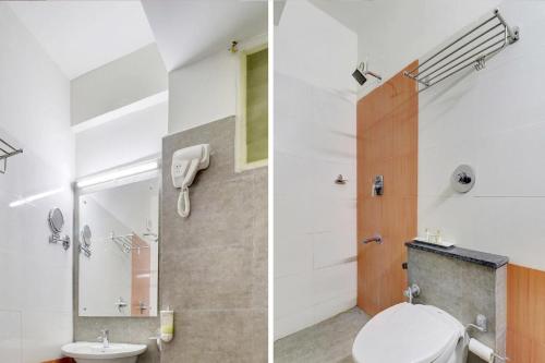 a bathroom with a toilet and a shower at Pine Tree Signature in Chennai
