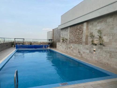 a swimming pool on top of a building at Urban Lifestyle 1BR in Westlands, Heated Pool, Gym, Workspace & Parking in Nairobi