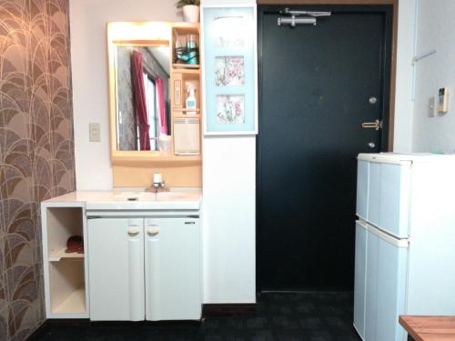 a kitchen with a white sink and a refrigerator at COTE sakuragawa "Room 201,301,401" - Vacation STAY 03134v in Osaka