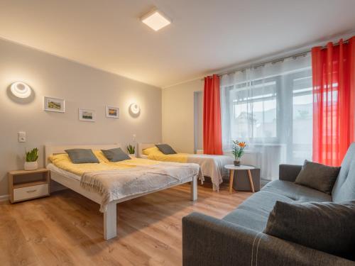 a bedroom with two beds and a couch at Grey Hill in Szklarska Poręba