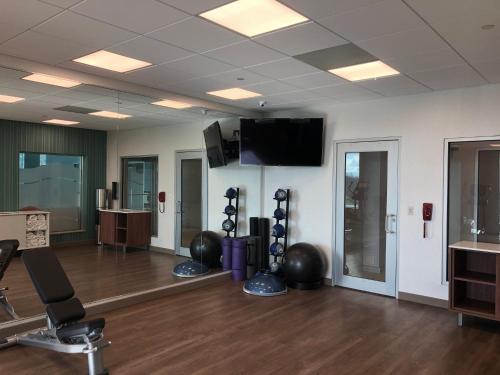 a gym with exercise balls and a flat screen tv at Holiday Inn Express & Suites Halifax Airport by IHG in Enfield