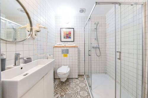 a bathroom with a sink toilet and a shower at My Place Ferdinand in Cluj-Napoca