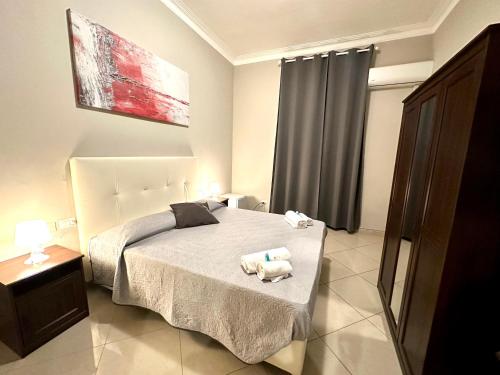a bedroom with a bed with two stuffed animals on it at Golden Milano Hotel in Milan