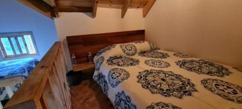 a bedroom with a large bed in a room at Mariposa - Cabañas Puerto del Zopilote in Pinal de Amoles