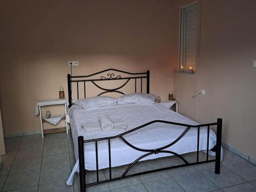 a bedroom with a bed with a black frame at Fully equipped apartment in Apokoronas in Nípos