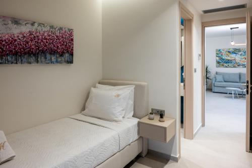 a bedroom with a bed and a painting on the wall at Horizon View Villa in Agios Nikolaos