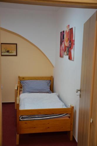 a bedroom with a wooden bed in a room at Apartmán Nad potokem in Český Rudolec
