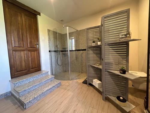 a bathroom with a walk in shower and a sink and a shower at Espace cocooning 