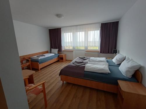 a hotel room with a bed and a desk at Dom Wczasowy Larix in Rewal