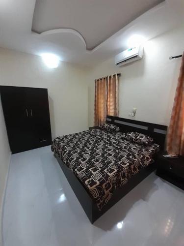 a bedroom with a bed in a room at F and B serviced apartment Abeokuta in Aro