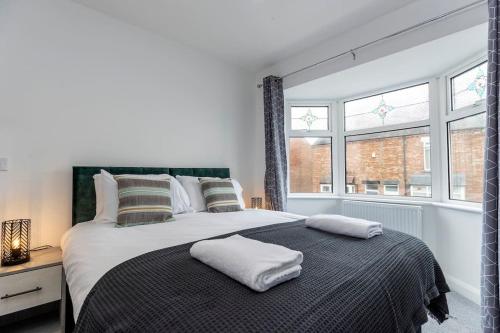 a bedroom with a large bed with two pillows on it at Stunning newly decorated House - TV in each Bedroom in Darlington