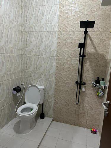 a bathroom with a toilet and a camera in it at Villa Magnifica by REQhome in Ciater-hilir