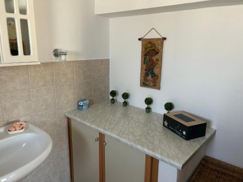 a bathroom with a sink and a counter with a sink at Gioia’s view in Loutra