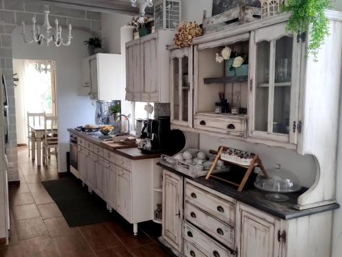 a kitchen with white cabinets and a counter top at Grotta dei Puntali B&B in Carini