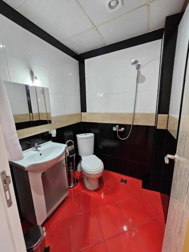 a bathroom with a toilet and a sink at Hotel Izvora in Ruse