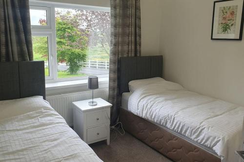 a bedroom with two beds next to a window at 3 bedroom house close to lough sheelin in Cavan