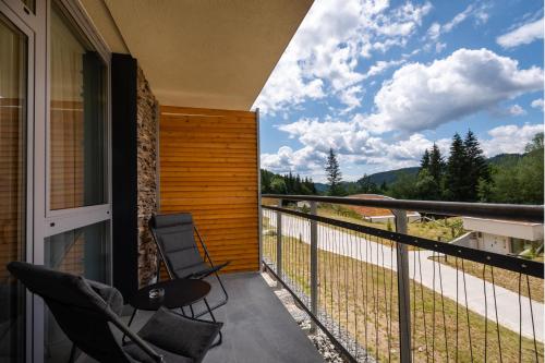 a balcony with chairs and a view of the mountains at TALBERG SK - Garage parking - Quiet place - Brand new apartments - Tále in Tale