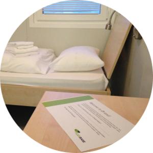 a circular picture of a bed with a sign on a table at Flexbase in Brekstad