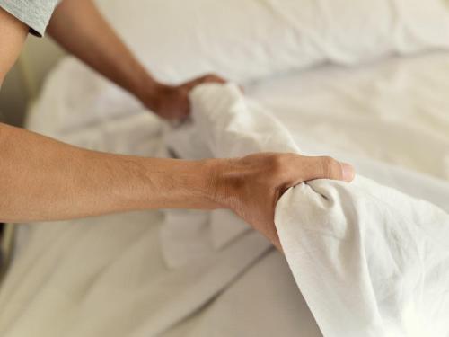 a persons hand is on top of a bed at Flexbase in Brekstad