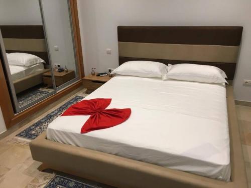 a bedroom with a bed with a red bow on it at 3 bedrooms villa at La Marsa 400 m away from the beach with private pool enclosed garden and wifi in La Marsa