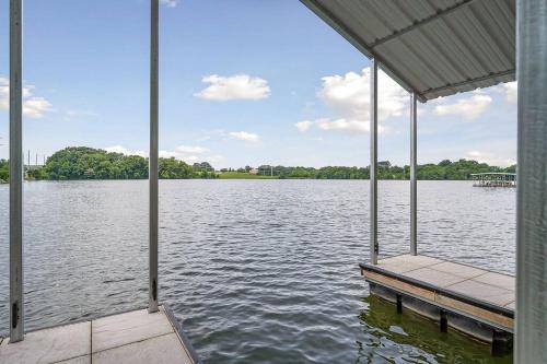 a dock on a lake with a view of the water at Lake Home, Dock, Fire Pit, Hot Tub, Game Room, Etc in Winchester