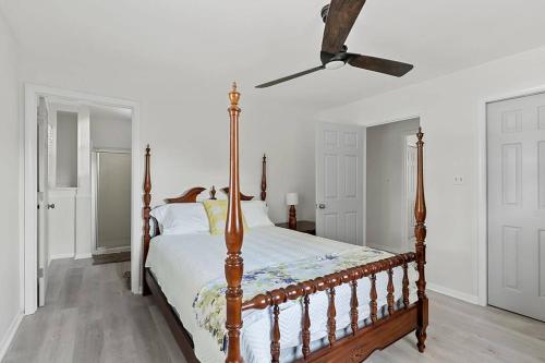 a bedroom with a bed and a ceiling fan at Lake Home, Dock, Fire Pit, Hot Tub, Game Room, Etc in Winchester