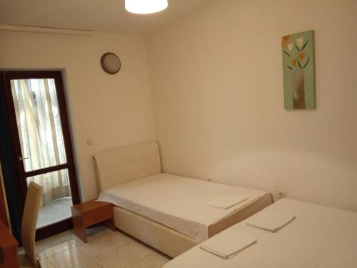 a small room with two beds and a window at Solar Apartments in Herceg-Novi