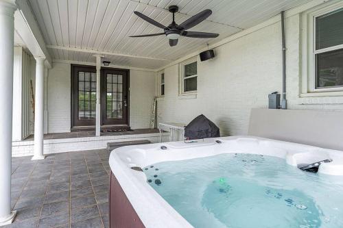 a hot tub on a house with a ceiling fan at Lake Home, Dock, Fire Pit, Hot Tub, Game Room, Etc in Winchester
